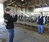 Connor Hickman, an FFA member and a junior at Tri-Valley High School, films Heidi Selken as she explains daily operations at Boadwine Dairy. For the past two years, Selken has been a part of the Adopt A Farmer program, which helps connect producers to urban schoolchildren.<br /><!-- 1upcrlf -->PHOTO BY JERRY NELSON