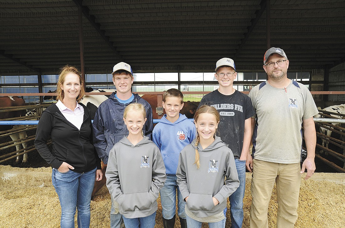 STACEY SMART/Dairy Star
The Staudinger family – Lexis (front, from left) and London; (back, from left) Angie, Ethan, Isaac, Eli and Brian – milks 2,300 cows and farms 2,800 acres near Reedsville, Wisconsin, with Brian’s parents, Bob and Mary Kay. On June 27, the family was busy preparing a string of 16 animals for their district Holstein show. Not pictured is the Staudingers’ youngest daughter, Graysen.